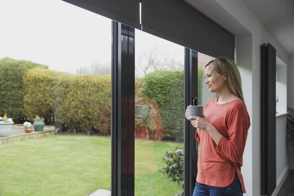 woman looking out bifold door